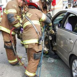 firefighters getting someone out of a car