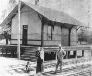 old photo of people standing on train tracks 